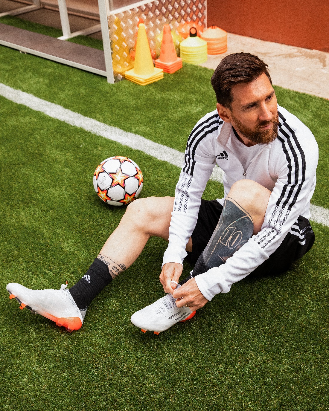 a person kneeling on the grass with a football ball
description automatically generated with low confidence